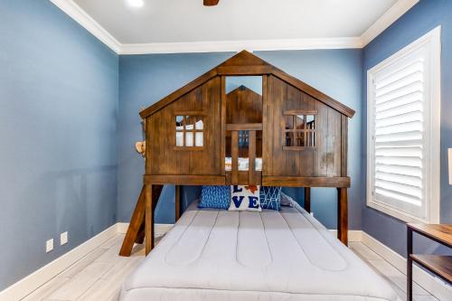 a bed in a room with blue walls at Lago Vista Retreat in Lago Vista