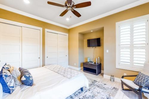a bedroom with a white bed and a ceiling fan at Lago Vista Retreat in Lago Vista
