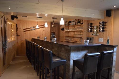 a bar in a restaurant with leather chairs at B & B Gmeineck in Seeboden