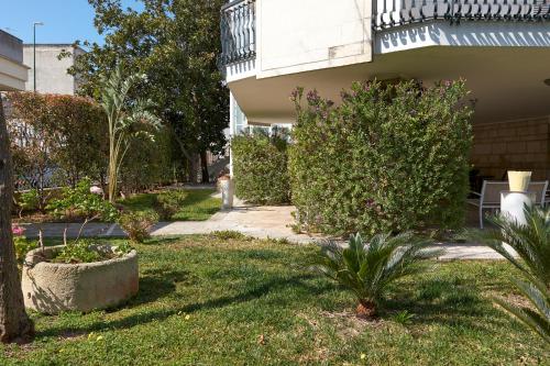 a person walking in the yard of a house at Il Giardino Di Flora con Piscina & Jacuzzi in Lecce