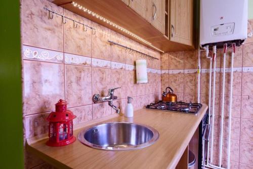 a kitchen counter with a sink and a stove at Apartament BEY in Szczecin