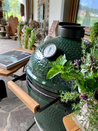 a large green pot sitting on a table with plants at Gästehaus Weiherhof in Alpbach