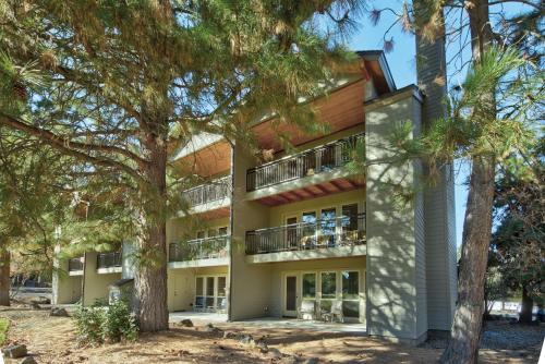 an apartment building with trees in front of it at Seventh Mountain Resort in Bend