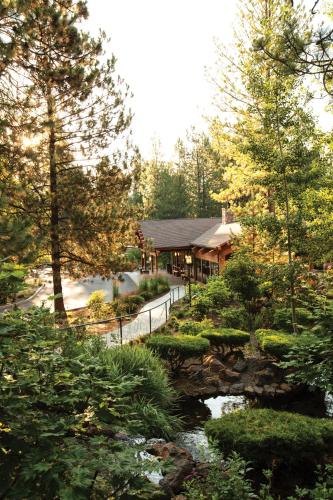 a house in the woods with a pond and trees at Seventh Mountain Resort in Bend