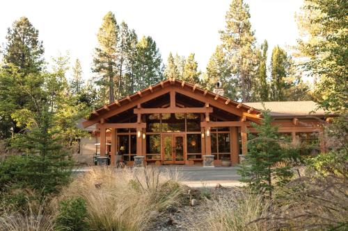 a large log cabin with trees in the background at Seventh Mountain Resort in Bend