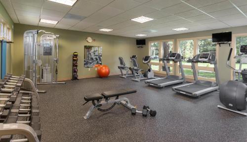 a gym with several treadmills and cardio machines at Seventh Mountain Resort in Bend