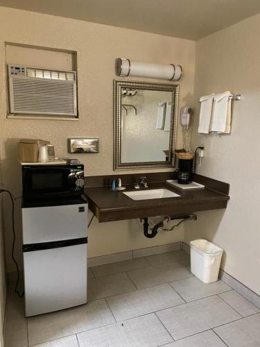 a bathroom with a sink and a mirror at Motel In The Pines in Munds Park