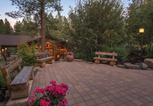 a patio with benches and flowers and a building at Seventh Mountain Resort in Bend