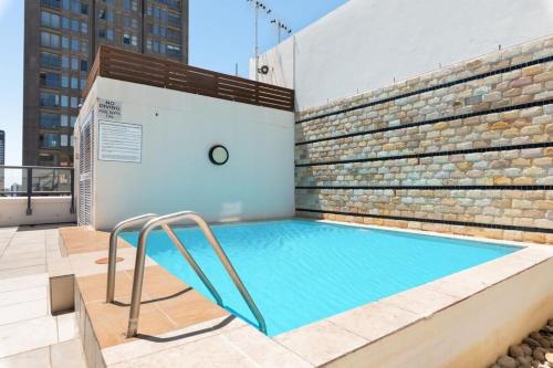 a swimming pool on the roof of a building at Stylish Apartment with Rooftop Pool and City Views in Cape Town