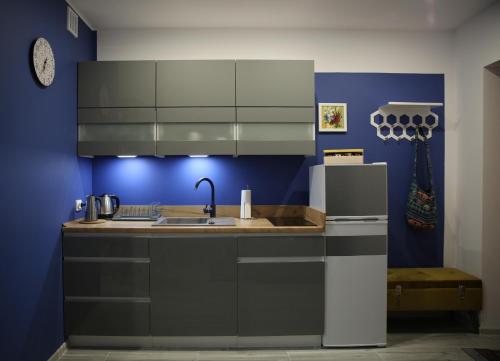a kitchen with a sink and a refrigerator at Apartament Dla Dwojga in Ustrzyki Dolne