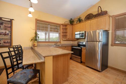 a kitchen with a stainless steel refrigerator and wooden cabinets at Westgate River Ranch Resort & Rodeo in River Ranch