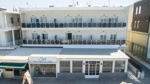 a white building with a balcony on top of it at KSP Studios in Perea