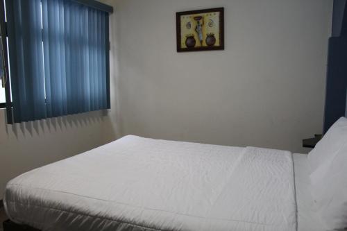 Postel nebo postele na pokoji v ubytování Invernadero Inn