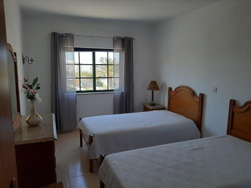 a hotel room with two beds and a window at Dunas do Alvor 239 one bedroom in Alvor