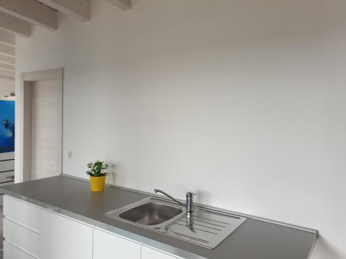 a kitchen with a sink in a white kitchen at Wellness & Spa, Villa STELLA - heated pool, facilities for children, close to beaches and the sea, Medulin - Istria in Pomer
