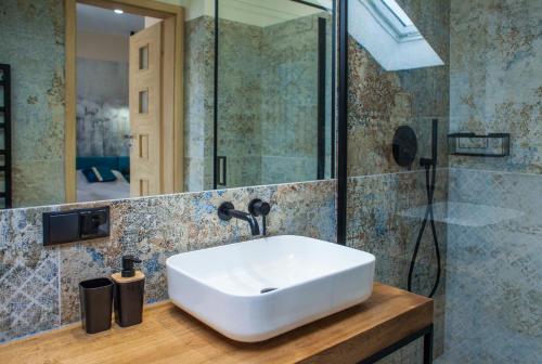 a bathroom with a white sink and a shower at ZOFIA in Władysławowo