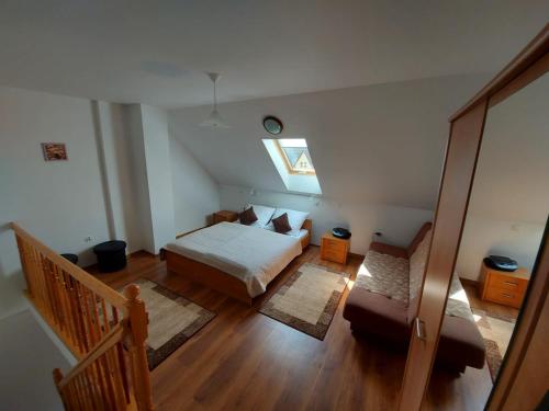 a bedroom with a bed and a window in a attic at Apartamenty Kołczewo in Kołczewo