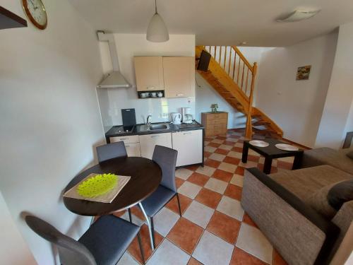 a kitchen and a living room with a table and chairs at Apartamenty Kołczewo in Kołczewo