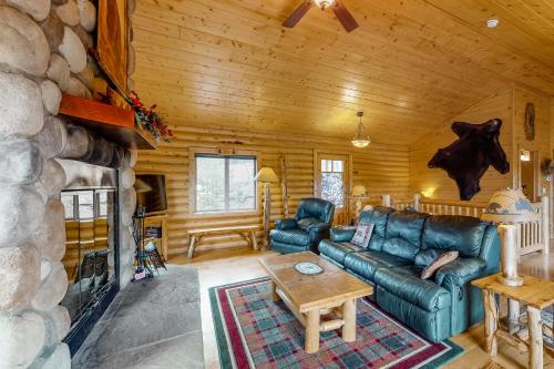 a living room with a couch and a fireplace at Bear Crossing in Divide
