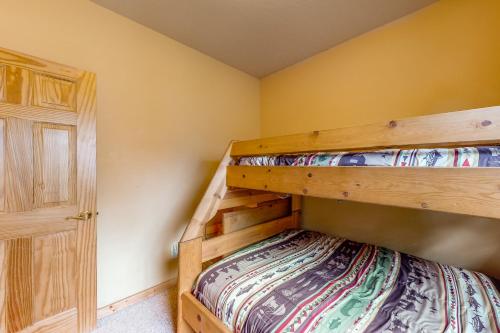 a bedroom with two bunk beds and a closet at Bear Crossing in Divide