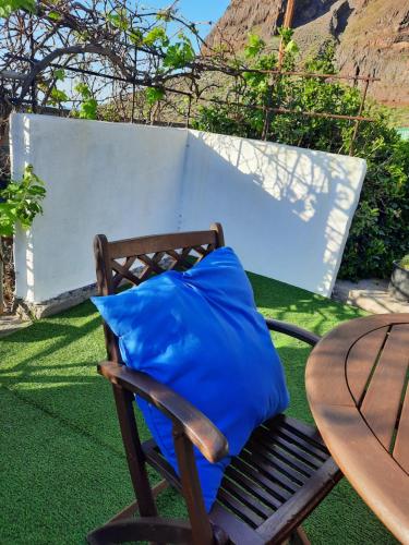 a blue pillow sitting on a chair next to a table at MI CUMANESA in Frontera
