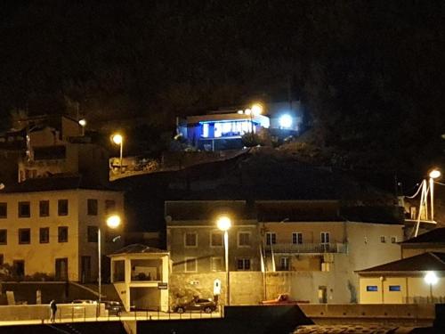 a group of buildings at night with lights at Casa da Rocha in Paul do Mar