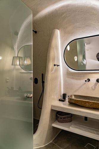 a bathroom with a sink and a mirror at Eternity Suites Santorini in Fira