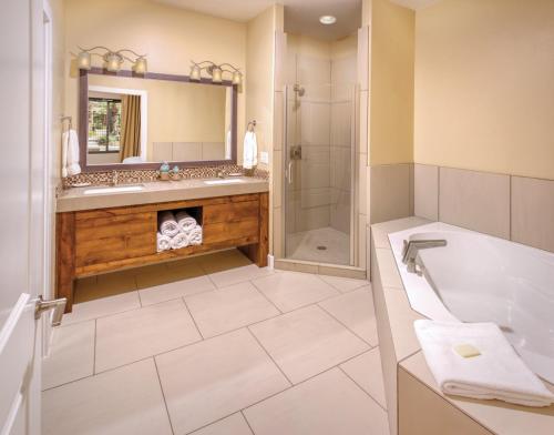 a bathroom with a tub and a shower at WorldMark Estancia in St. George