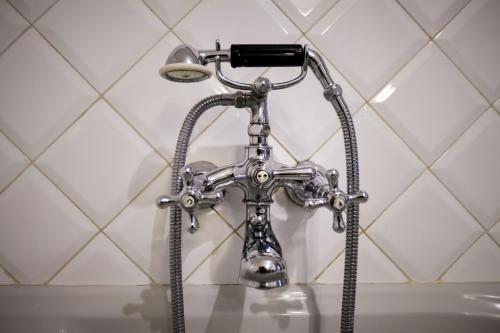 a shower in a bathroom with a sink at LA PITA AGORDINA in Cancellade