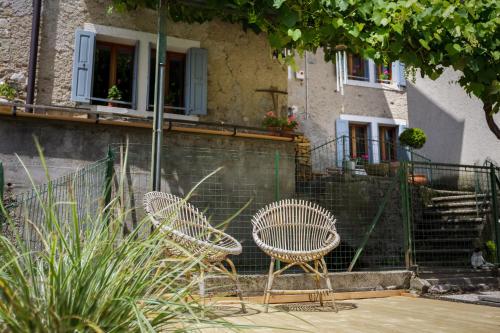 two chairs sitting in front of a building at LA PITA AGORDINA in Cancellade