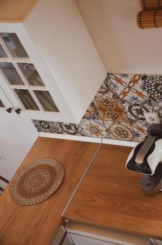 a room with a tile floor and a wooden table at Samothrakis Michelangelo 101 Luxury apartment in Samothraki