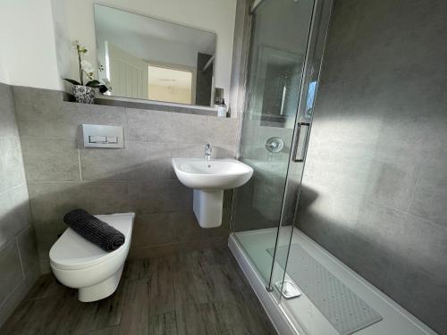 a bathroom with a toilet and a sink and a shower at Ivy Tower Cottages in Saint Florence