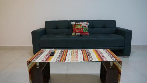 a living room with a couch and a coffee table at Edificio Tofino in Quito