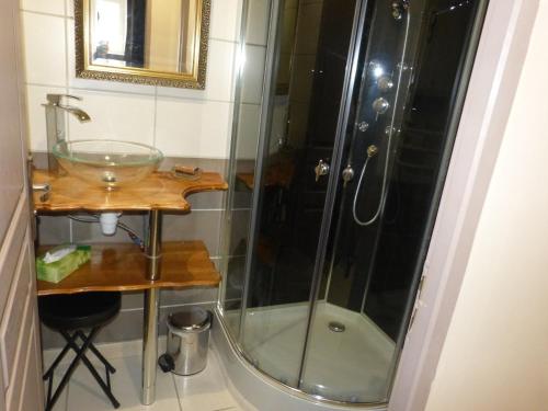 a shower in a bathroom with a sink and a glass shower at La Pause Ardéchoise in Saint-Remèze