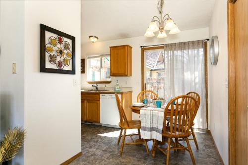 a kitchen with a table and chairs and a kitchen with a window at 8639 Ustick in Boise