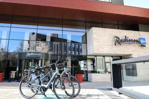 a group of bikes parked in front of a building at Radisson Blu Hotel, Hasselt in Hasselt