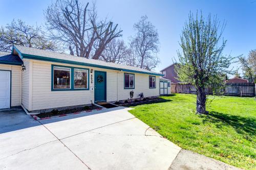 a white house with a green door and a yard at 8639 Ustick in Boise