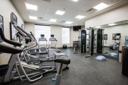 a gym with treadmills and machines in a room at Holiday Inn Hotel & Suites Calgary South - Conference Ctr by IHG in Calgary