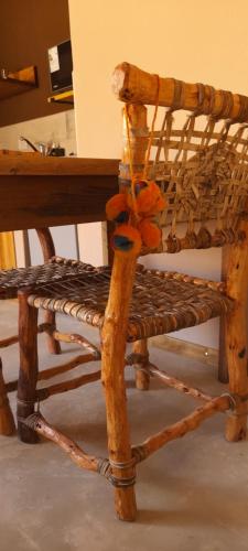 a stuffed teddy bear sitting on a wooden chair at Tierra Quebrada Cabañas in Purmamarca