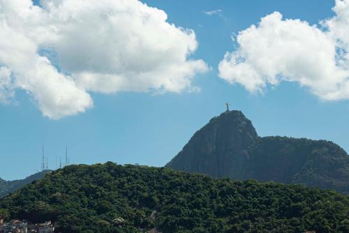 a mountain with a cross on top of it at Mar Palace Copacabana Hotel in Rio de Janeiro