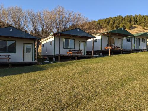 a row of mobile homes on a grassy hill at Eagles Landing Campground in Sturgis