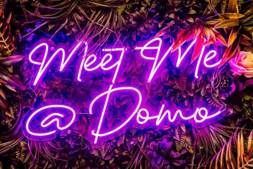 a neon sign that says fire up done at Domo Boutique Hotel in Oldbury