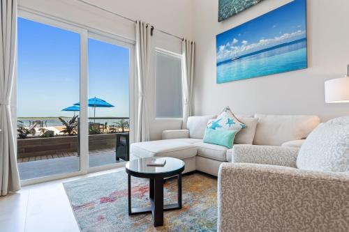 a living room with a couch and a table at Sunset Caribe Belize in San Pedro