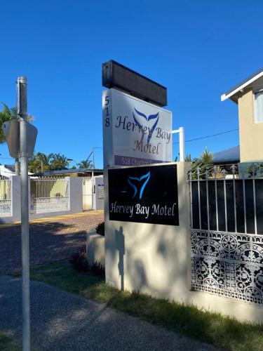 a sign for a happybay auction in front of a house at Hervey Bay Motel in Hervey Bay