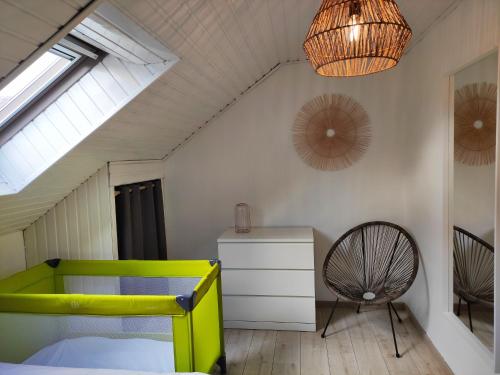 a bedroom with a yellow bed and a chair at Lacs de l'eau d'heure Chez Oma in Cerfontaine