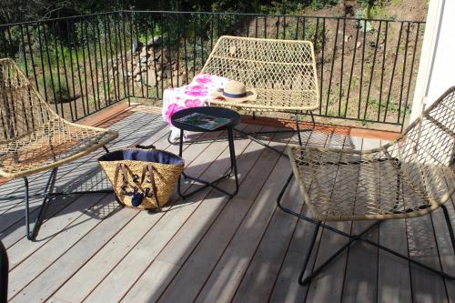 a patio with two chairs and a table at Casa Marina Cargèse in Cargèse