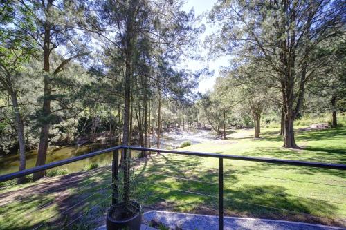 a balcony with a view of a river and trees at Amaroo Escape in Coneac