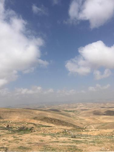 a view of the desert under a cloudy sky at Sun, Mountain & Adventure in Arad