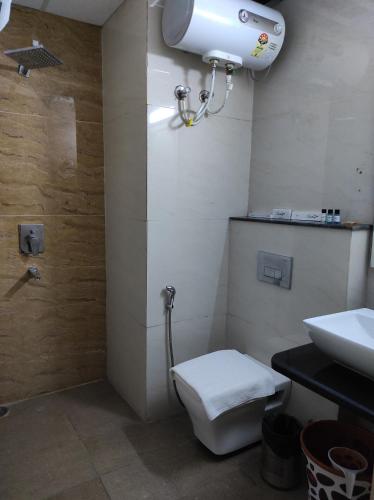 a bathroom with a toilet and a sink at The Dwelling Paradise in Greater Noida