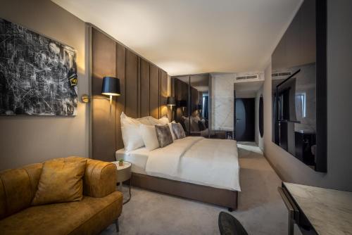 a hotel room with a bed and a couch at Grand Hotel Adriatic in Opatija